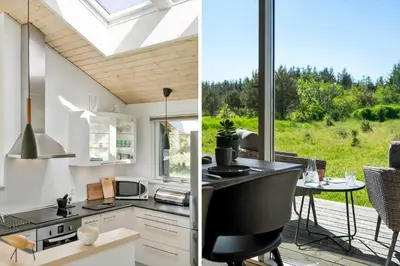 a kitchen with a large window and a dining area with a table at BL512-Saltum-Trehoje-2 in Saltum