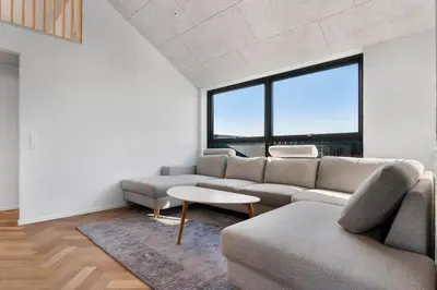 a living room with a couch and a table at LK2144-Lokken-Kringelbaekvej-31 in Løkken