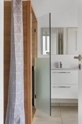 a bathroom with a glass shower with a sink at LK2144-Lokken-Kringelbaekvej-31 in Løkken