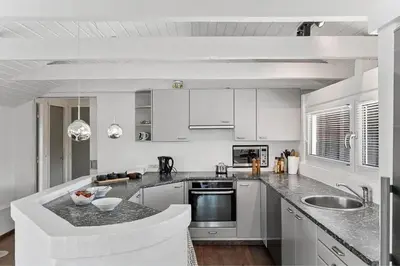 a kitchen with white cabinets and a counter top at BL1375-Blokhus-Klitvejen-15 in Blokhus