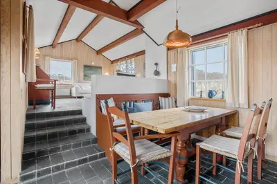 a kitchen and dining room with a wooden table and chairs at BL1241-Saltum-Bondagervej-2 in Saltum
