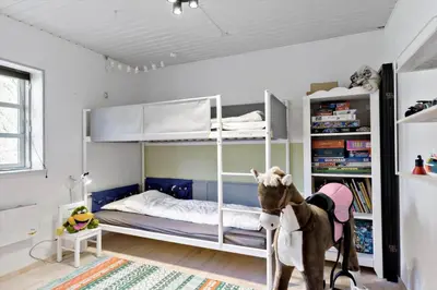 a childs bedroom with bunk beds and a stuffed animal at BL1454-Pandrup-Rodhusvej-215 in Pandrup