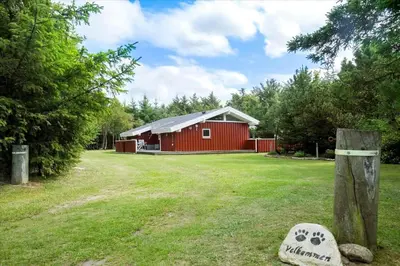 a red barn in a field next to a yard at BL1092-Saltum-Doggerbanke-2 in Saltum