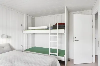a bedroom with two bunk beds and a bed at BL1349-Pandrup-Rodhus-Klitvej-217 in Pandrup