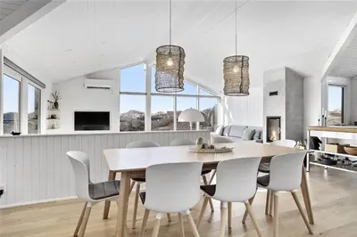 a kitchen and dining room with a table and chairs at BL1450-Blokhus-Klitvejen-99 in Blokhus
