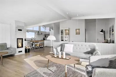 a living room with a couch and a table at BL1450-Blokhus-Klitvejen-99 in Blokhus