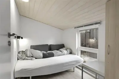 a couch sitting in a room with a window at BL1258-Blokhus-Frederiksensvej-19 in Blokhus
