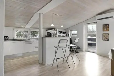 a kitchen with two chairs and a table in it at BL1258-Blokhus-Frederiksensvej-19 in Blokhus