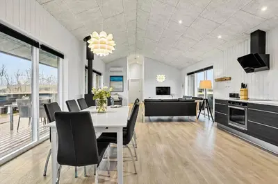 a kitchen and dining room with a table and chairs at LK2167-Lokken-Kringelbaekvej-12 in Løkken