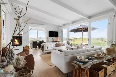 a living room with a couch and a table at LK2173-Lokken-Ruthsvej-9 in Løkken