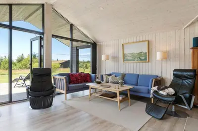 a living room with a blue couch and chairs at BL1511-Saltum-Tolhoj-21 in Saltum
