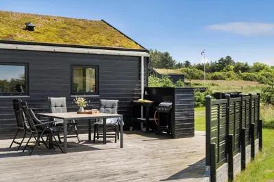 a patio with a table and chairs and a house at BL1511-Saltum-Tolhoj-21 in Saltum