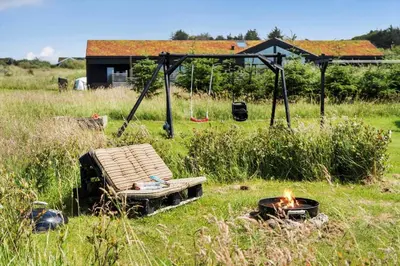 a fire pit in a field next to a house at BL1511-Saltum-Tolhoj-21 in Saltum