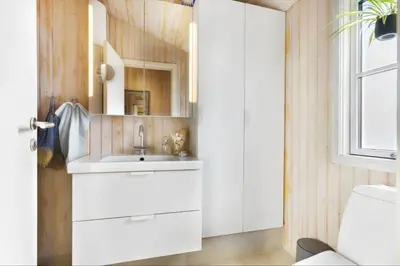 a bathroom with a white sink and a mirror at BL1587-Blokhus-Karnoevej-1 in Blokhus
