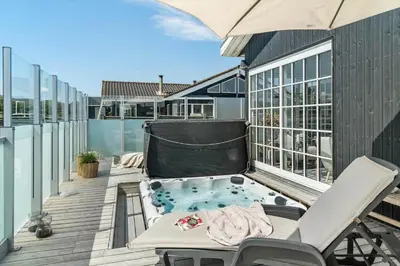 a hot tub on the balcony of a house at BL1637-Blokhus-Norresundbyvej-2 in Blokhus