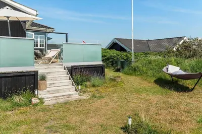a house with a yard with a hammock and stairs at BL1637-Blokhus-Norresundbyvej-2 in Blokhus