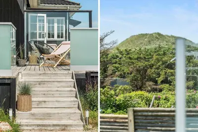 a house with a staircase leading up to a house with a mountain at BL1637-Blokhus-Norresundbyvej-2 in Blokhus