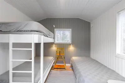 a bedroom with two bunk beds and a ladder at BL946-Blokhus-Graevlingevej-8 in Blokhus