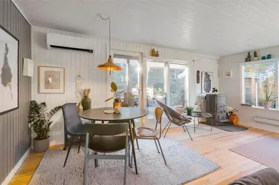 a dining room with a table and chairs at BL946-Blokhus-Graevlingevej-8 in Blokhus