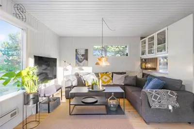 a living room with a couch and a table at BL946-Blokhus-Graevlingevej-8 in Blokhus