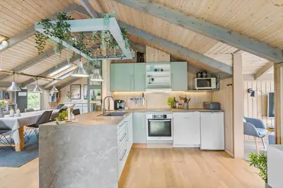a kitchen with white appliances and a dining room at BL1438-Blokhus-Bloksbjerg-82 in Blokhus
