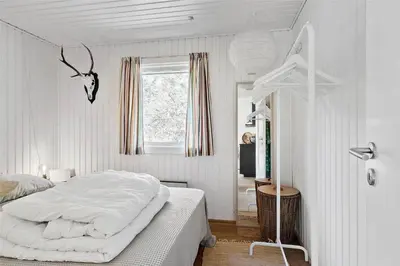 a white bedroom with a bed and a window at BL1716-Saltum-Viborgvej-2 in Saltum