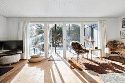 a living room with a television and a table and chairs at BL1716-Saltum-Viborgvej-2 in Saltum