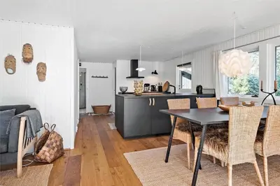 a kitchen and living room with a table and chairs at BL1716-Saltum-Viborgvej-2 in Saltum
