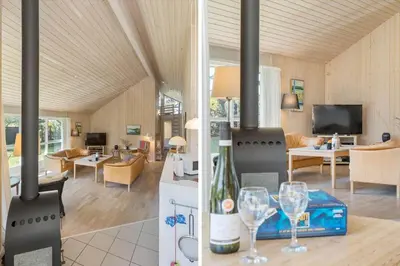 a kitchen and living room with a stove with wine glasses at BL1382-Blokhus-Gyvelvej-20-A in Blokhus