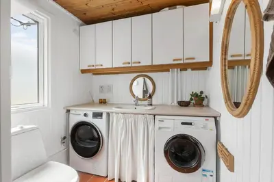 a bathroom with a washing machine and a sink at BL1020-Pandrup-Hunetorp-Klitvej-257 in Pandrup