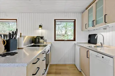 a kitchen with white cabinets and a sink at BL1735-Pandrup-Rodhus-Skolevej-56 in Pandrup