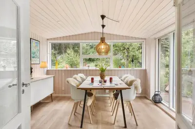 a dining room with a table and chairs at BL1396-Blokhus-Laerkevej-8 in Blokhus