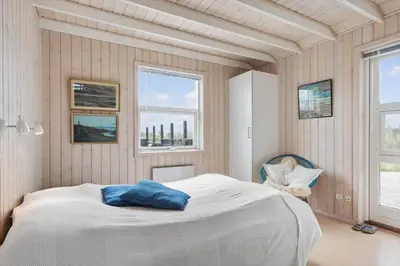 a bedroom with a white bed and two windows at BL189-Saltum-Bondagervej-71 in Saltum