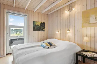 a bedroom with a white bed and a window at BL189-Saltum-Bondagervej-71 in Saltum