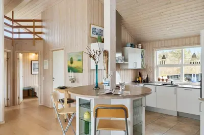a kitchen with a table and chairs in a room at BL189-Saltum-Bondagervej-71 in Saltum