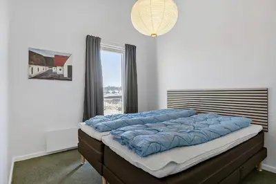 a bed in a room with a window at BL1538-Blokhus-Ferren-42 in Blokhus