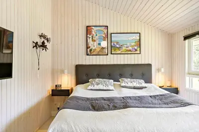 a bedroom with a bed with two pillows on it at BL1566-Saltum-Lille-Fiskerbanke-3 in Saltum