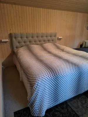 a bed in a room with a bedspread on it at BL1566-Saltum-Lille-Fiskerbanke-3 in Saltum
