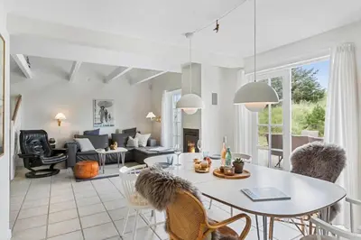a living room with a table and chairs at BL1401-Blokhus-Ferren-Syd-78 in Blokhus