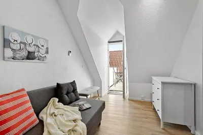 a living room with a couch and a table at BL1582-Blokhus-Strandvejen-14-Lejl-11 in Blokhus