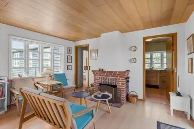 a living room with a couch and a fireplace at BL1548-Blokhus-Paa-Bakken-10 in Blokhus