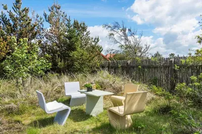 a group of chairs and a table in a yard at BL1548-Blokhus-Paa-Bakken-10 in Blokhus