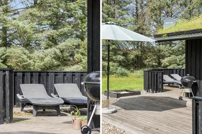 a patio with chairs and an umbrella and a grill at BL959-Saltum-Nordvestvej-6 in Saltum