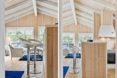 a room with chairs and a kitchen with wooden ceilings at BL959-Saltum-Nordvestvej-6 in Saltum