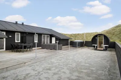 a house with a deck with a table and a grill at BL1470-Saltum-Faaborgvej-6 in Saltum