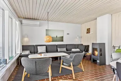 a living room with a couch and a table and chairs at BL1775-Pandrup-Rodhus-Klitvej-335 in Pandrup