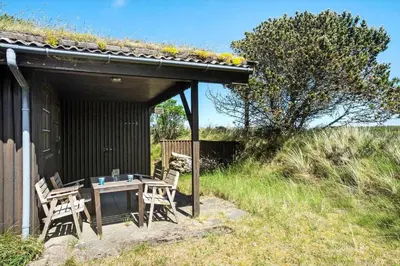 a patio with a table and chairs under a building at BL1570-Pandrup-Flaskehalsen-13-A in Pandrup