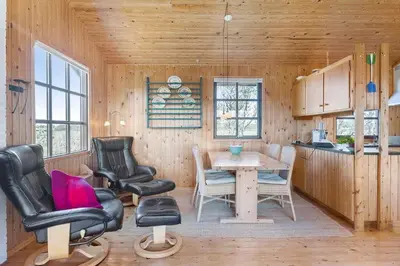 a room with a table and two chairs and a kitchen at BL1570-Pandrup-Flaskehalsen-13-A in Pandrup