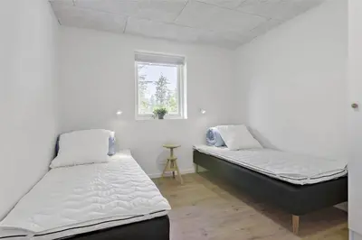 two beds in a room with white walls and a window at BL1358-Saltum-Solmarken-5 in Saltum