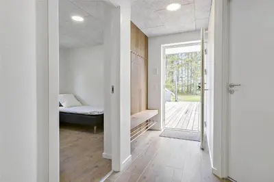 a bedroom with a bed and a door to a porch at BL1358-Saltum-Solmarken-5 in Saltum